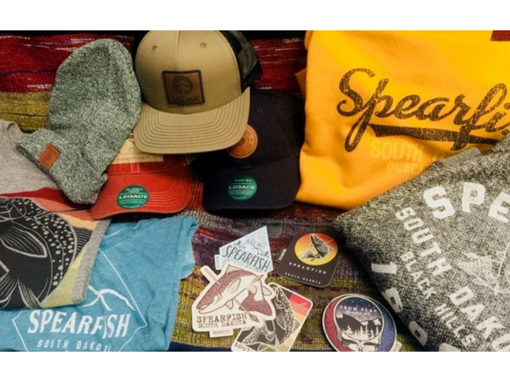 An Array of Spearfish Clothing and Stickers that can be found at Ventana.